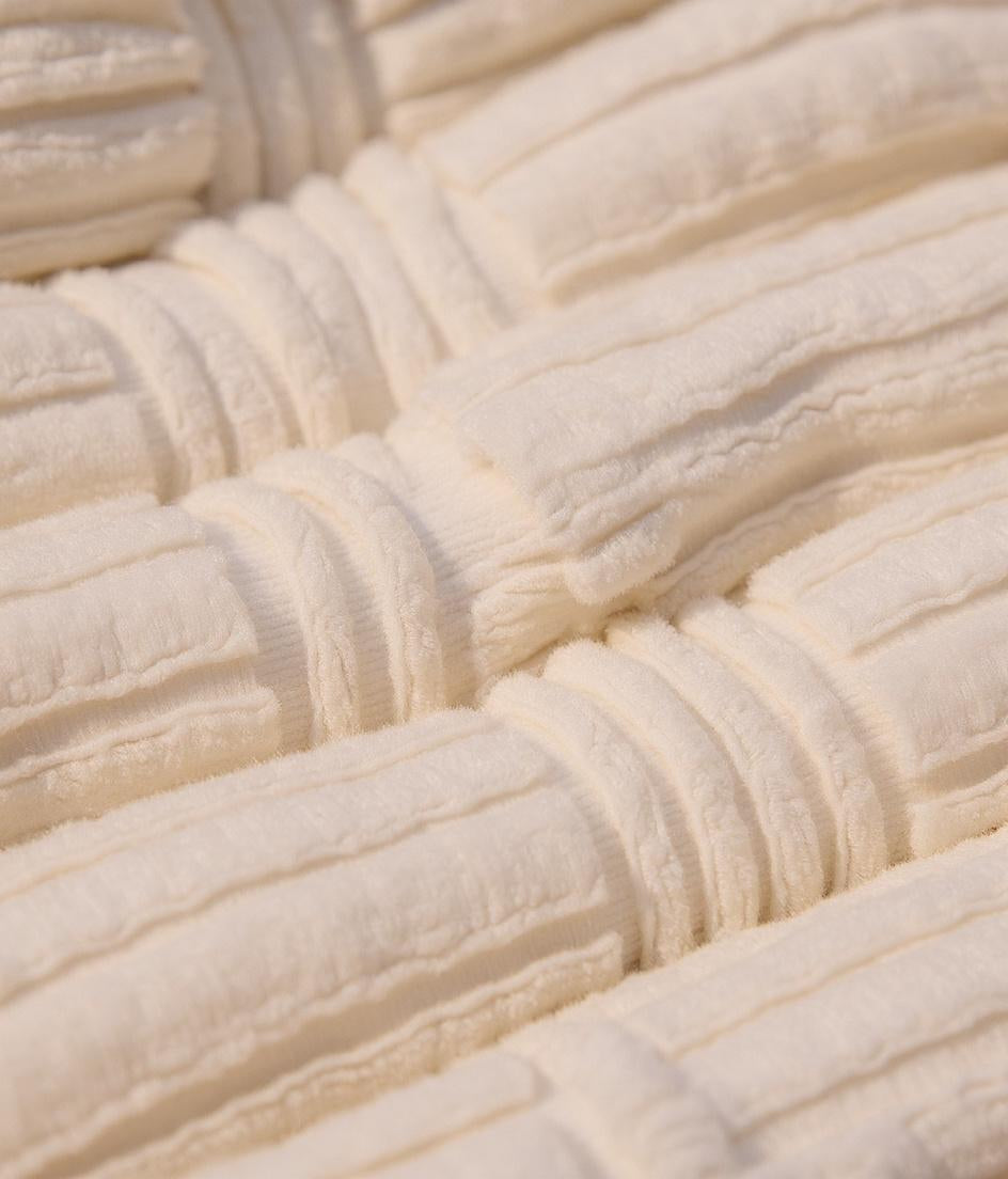 Close-up of plush Turkish cotton towel texture showing thick spa-weight loops