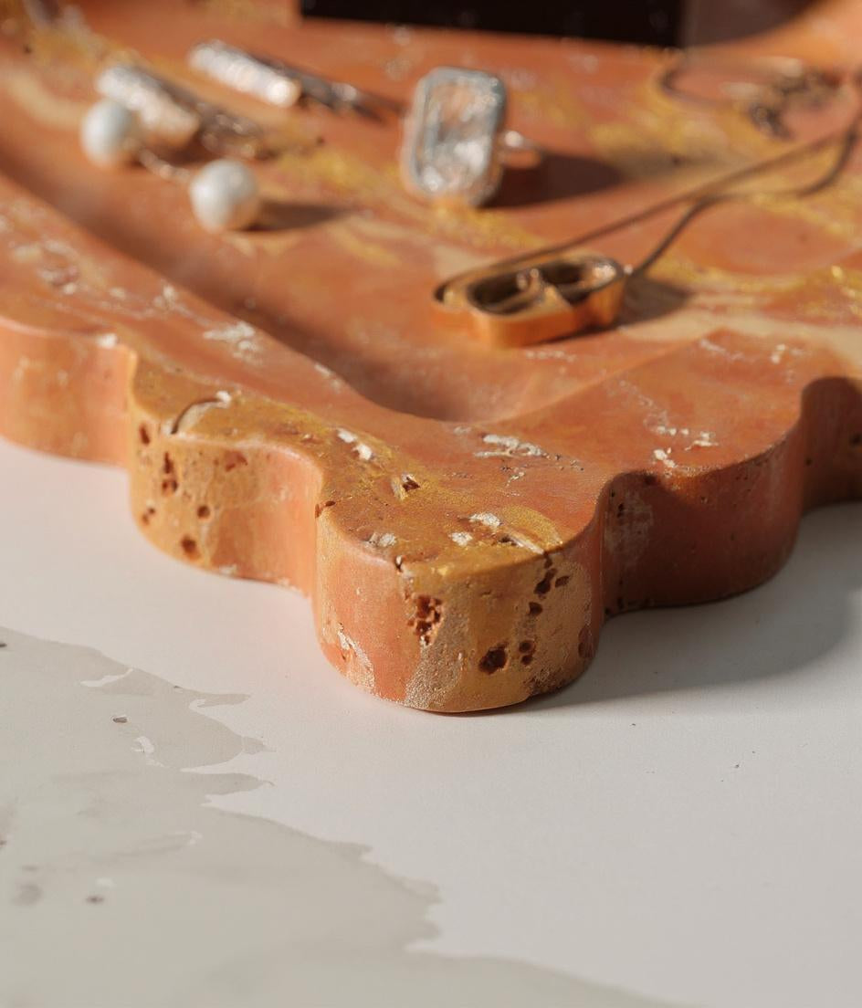 Close-up of red travertine tray edge showing natural pits and veining