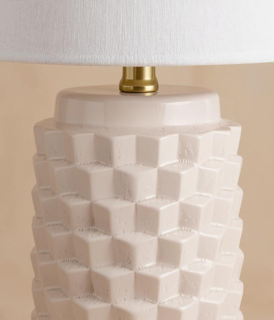 Close-up of textured ceramic lamp base with brass hardware